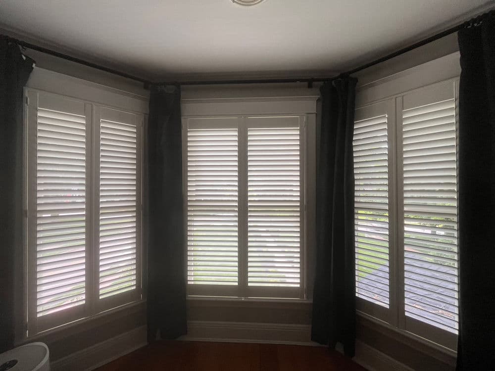 Plantation Shutters Installed Across Two Bay Windows image